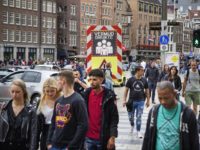 no masks for Day trippers and tourists walk in Amsterdam on July 25, 2020 as the municipality has stricter supervision over the weekend and one-way traffic was set up for pedestrians on a certain section of the Kalverstraat shopping street in Amsterdam due to the increasing number of infections caused …