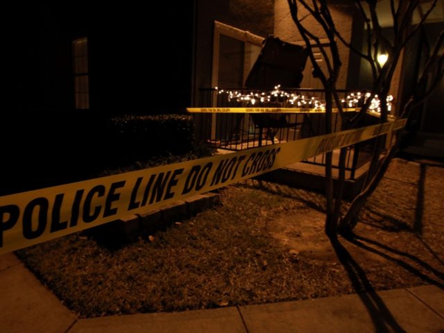 GRAPEVINE, TX - DECEMBER 25: Police line tape surrounds an apartment building where seven