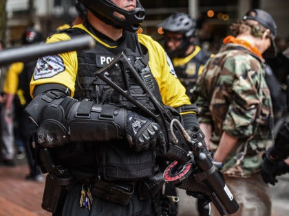 PORTLAND, OR - AUGUST 17: A member of the Portland police holds a pepper ball gun during a