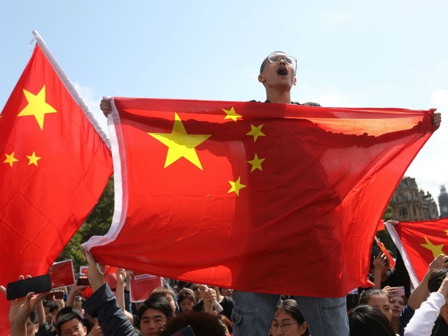 Counter-protesters hold up Chinese flags to oppose the protesters gathering in central London to attend a march organised by StandwithHK and D4HK in support of Pro-democracy protests in Hong Kong, on August 17, 2019. - Hong Kong's pro-democracy movement faces a major test this weekend as it tries to muster another huge crowd following criticism over a recent violent airport protest and as concerns mount over Beijing's next move. (Photo by Isabel Infantes / AFP) (Photo by ISABEL INFANTES/AFP via Getty Images)