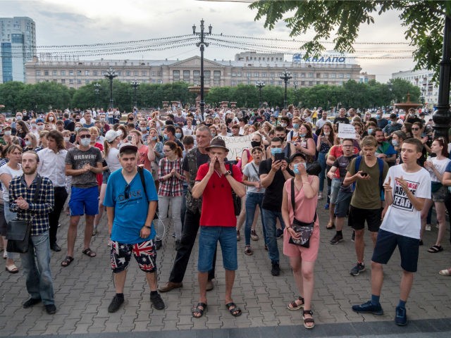 People holding posters reading "freedom for Sergei Furgal" gather to attend an unsanctione