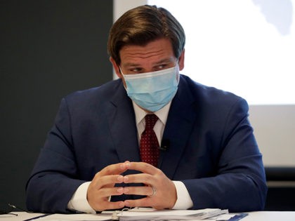 Florida Gov. Ron DeSantis listens during a news conference at the old Pan American Hospita