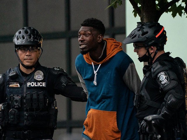 SEATTLE, WA - JULY 01: Police detain a person as city crews dismantle the Capitol Hill Organized Protest (CHOP) area outside of the Seattle Police Department's vacated East Precinct on July 1, 2020 in Seattle, Washington. Police reported making at least 31 arrests while clearing the CHOP area this morning. …