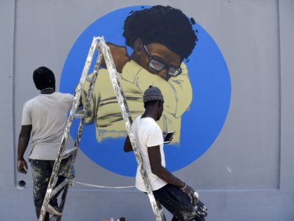 Members of the Senegalese graffitti collective RBS CREW, tag a wall of the Centre des Oeuv