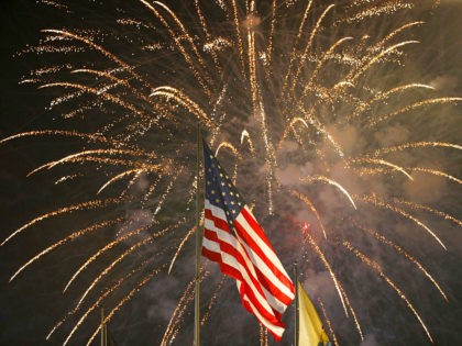 FILE - In this July 4, 2015, file photo, fireworks explode behind a United States flag during a Fourth of July celebration at State Fair Meadowlands in East Rutherford, N.J. With fewer professional celebrations on July 4, 2020, many Americans are bound to shoot off fireworks in backyards and at …