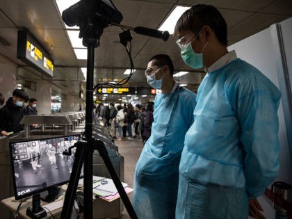 TAIPEI - MARCH 19 : Taipei metro staff in the MRT station monitor the temperatures of pass