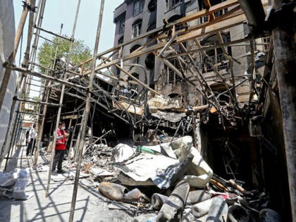 Iranian security and rescue staff work at the site of an explosion at the Sina At'har health centre in the upmarket northern neighbourhood of Tajrish in the capital Tehran on July 1, 2020. - Iranian police questioned four people as part of investigations into a powerful explosion that killed 19 …