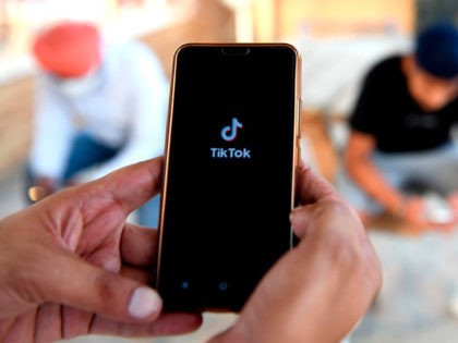 Indian mobile users browses through the Chinese owned video-sharing 'Tik Tok' app on a smartphones in Amritsar on June 30, 2020. - TikTok on June 30 denied sharing information on Indian users with the Chinese government, after New Delhi banned the wildly popular app citing national security and privacy concerns. …