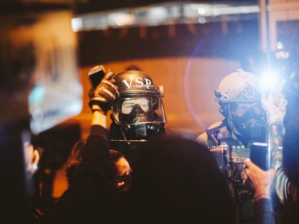 RICHMOND, VA - JUNE 14: Police look on as protesters surround the police head quarters to