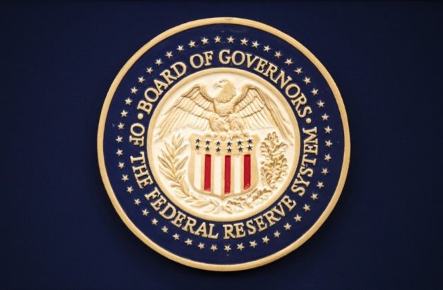 This July 31, 2019, file photo, shows the Federal Reserve logo ahead of the start of a scheduled news conference by Chairman Jerome Powell in Washington. The Federal Reserve says it purchased $1.3 billion in corporate bonds in late June 2020 as part of its effort to keep U.S. interest …