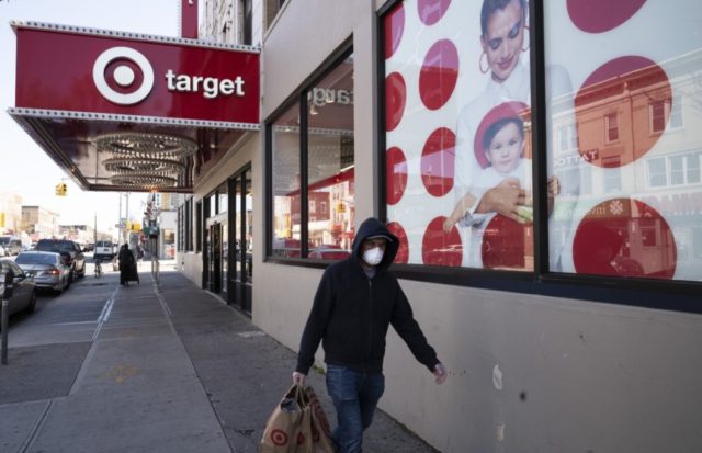 In this April 6, 2020 file photo, a customer wearing a mask carries his purchases as he leaves a Target store during the coronavirus pandemic in the Brooklyn borough of New York. Target has joined a growing list of major retailers that will require customers at all their stores to &hellip;