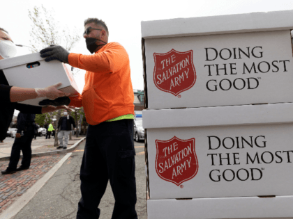 People distribute food donated by the Salvation Army, Friday, May 8, 2020, in Chelsea, Mas