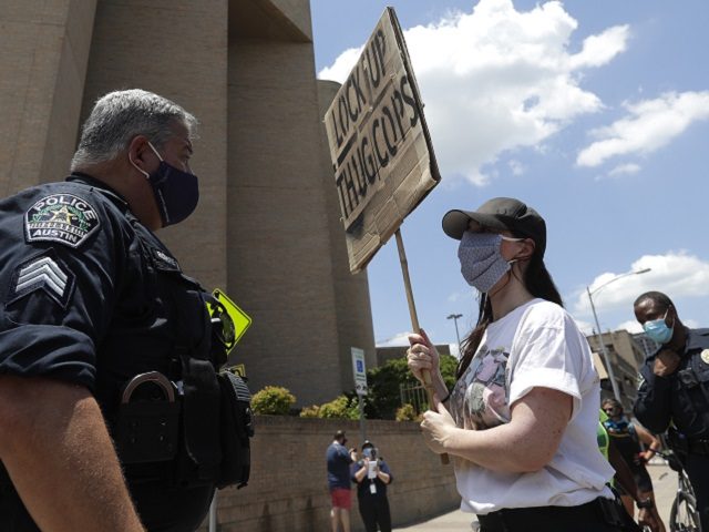 A demonstrator talks with Austin police in Austin, Texas, Saturday, June 6, 2020, where a group gathered to protest the death of George Floyd, a black man who was in police custody in Minneapolis. Floyd died after being restrained by Minneapolis police officers on Memorial Day.(AP Photo/Eric Gay)