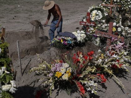 A worker digs a grave in a section of the Municipal Cemetery of Valle de Chalco opened two months ago to accommodate the surge in deaths amid the ongoing coronavirus pandemic, on the outskirts of Mexico City, Thursday, July 2, 2020. (AP File Photo/Rebecca Blackwell)