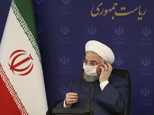 In this photo released by the official website of the office of the Iranian Presidency, President Hassan Rouhani adjusts his face mask in a meeting of the national headquarters of the fight against the COVID-19, in Tehran, Iran, Saturday, July 18, 2020. He estimated as many as 25 million Iranians …