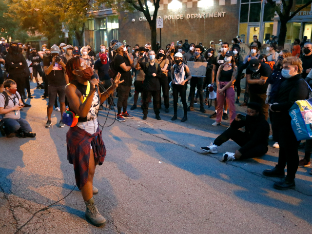 Ariel Atkins, a lead organizer for Black Lives Matter Chicago, leads a protest Monday, Aug. 10, 2020, outside the Chicago Police Department's District 1 station in Chicago. (AP Photo/Charles Rex Arbogast)