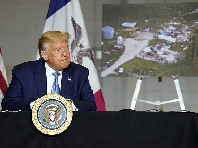 President Donald Trump listens during a briefing on Iowa flood damage and recovery efforts