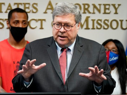 Attorney General William Barr talks to the media during a news conference about Operation Legend, a federal task force formed to fight violent crime in several cities, Wednesday, Aug. 19, 2020, in Kansas City, Mo. Behind Barr is Raphael Taliferro, and Charron Powell, the parents of 4-year-old LeGend Taliferro who …