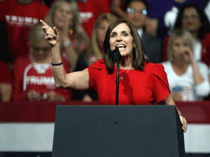 In this Feb. 19, 2020, file photo, Sen. Martha McSally, R-Ariz., speaks at a rally for President Donald Trump in Phoenix. McSally is volunteering at the Salvation Army. Mark Kelly is using his background as an astronaut to entertain kids stuck at home. The global pandemic that is shaking up …