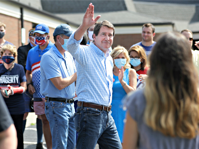 Former U.S. Ambassador to Japan Bill Hagerty waves to supporters at a polling place Thursday, Aug. 6, 2020, in Brentwood, Tenn. Hagerty and Dr. Manny Sethi are competing to become the GOP nominee in the race to replace retiring Republican Sen. Lamar Alexander. (AP Photo/Mark Humphrey)