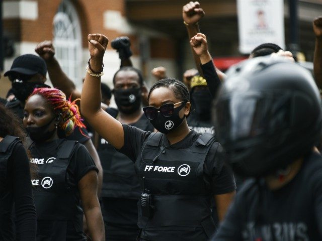 People take part in an Afrikan Emancipation Day reparations march, in Brixton, south Londo