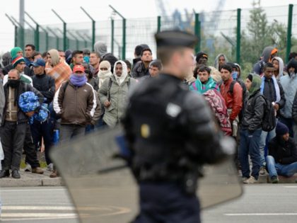 Illegal immigrants wait to be expelled from their camp at Calais on May 28, 2014. French p