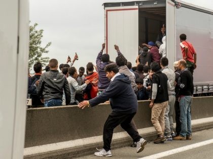 Illegal migrants attempt to hide in lorries heading for England, in the French northern harbour of Calais, on June 17, 2015. AFP PHOTO / PHILIPPE HUGUEN (Photo credit should read PHILIPPE HUGUEN/AFP via Getty Images)