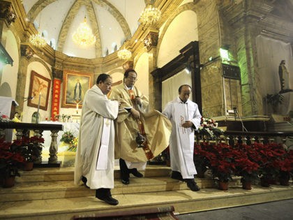 A Chinese archbishop, Li Shan(C) attends the Christmas Eve mass at a Catholic church in Be