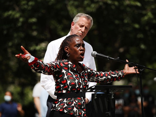 NEW YORK, NEW YORK - JUNE 04: New York Mayor Bill de Blasio listens as his wife, First Lady Chirlane McCray, speaks to an estimated 10,000 people as they gather in Brooklyn’s Cadman Plaza Park for a memorial service for George Floyd, the man killed by a Minneapolis police officer …