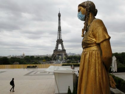 FILE- In this file photo dated Monday, May 4, 2020, a statue wears a mask along Trocadero
