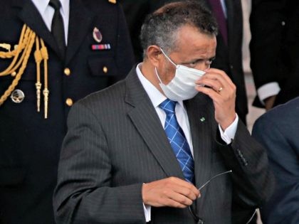 Director General of the World Health Organization, Tedros Adhanom Ghebreyesus, adjusts a face mask as he attends the Bastille Day military parade, Tuesday, July 14, 2020 in Paris. France are honoring nurses, ambulance drivers, supermarket cashiers and others on its biggest national holiday Tuesday. Bastille Day's usual grandiose military parade …