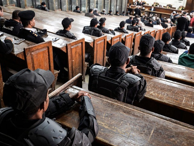 Members of the Egyptian security forces are seen seated on the benches at a make-shift courthouse in southern Cairo on December 2, 2018, during a trial session for former president Mohamed Morsi who was ousted in 2013 along with other members of the now-banned Muslim Brotherhood on charges of breaking …