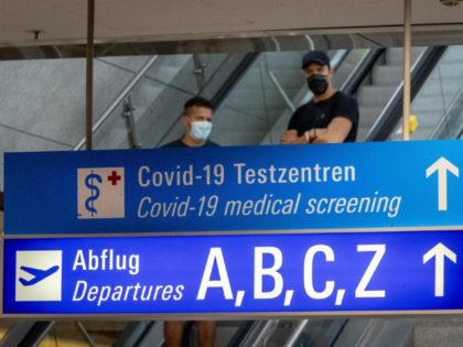 A sign recently fixed shows the way to the Covid-19 test center at the airport in Frankfur