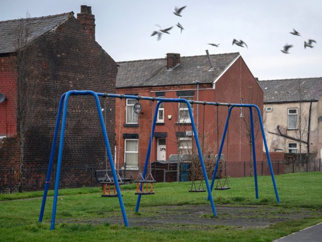 MANCHESTER, ENGLAND - DECEMBER 04: A children's play area sits next to terraced homes in t