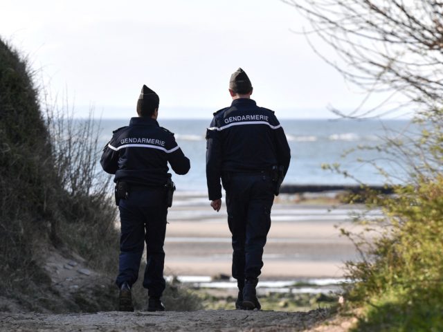 French Gendarmes patrol the beaches at Tardinghen near the northern port city of Calais on