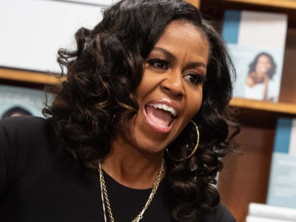 Former US first lady Michelle Obama appears at a book signing on the first anniversary of