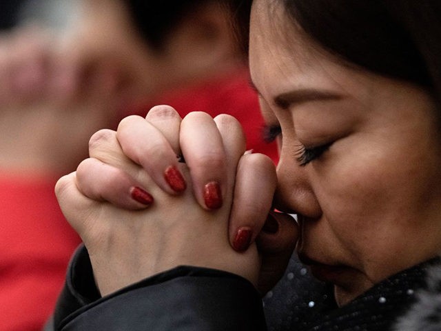 A woman attends a Christmas eve mass at the Xishiku Cathedral in Beijing on December 24, 2