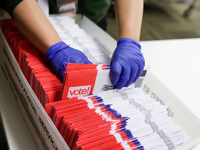 Election workers sort vote-by-mail ballots for the presidential primary at King County Ele