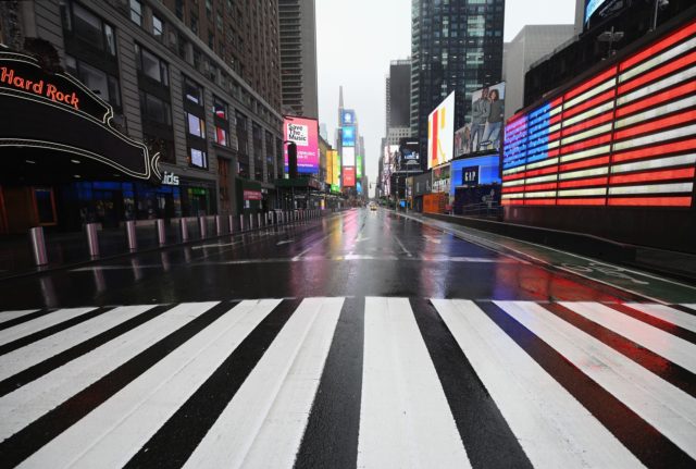 TOPSHOT - A nearly empty Times Square is seen on March 23, 2020 in New York City. - Wall Street fell early March 23, 2020 as Congress wrangled over a massive stimulus package while the Federal Reserve unveiled new emergency programs to boost the economy including with unlimited bond buying. …