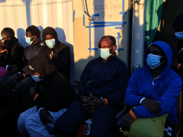Migrants wearing protective facemasks on board of the humanitarian aid boat Ocean Viking,