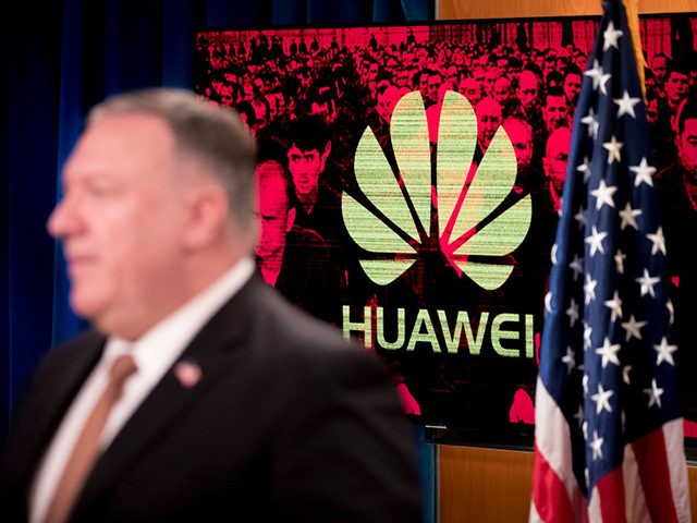A monitor displays the logo for Huawei behind Secretary of State Mike Pompeo as he speaks during a news conference at the State Department in Washington,DC on July 15, 2020. - US Secretary of State Mike Pompeo said Wednesday he will visit Britain and Denmark next week, days after London …