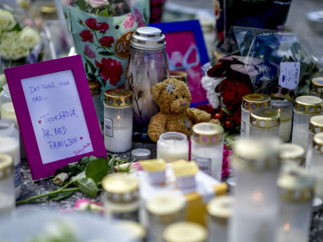 A makeshit memorial with candles, flowers, a teddy bear and a note is seen at the site where a twelve year old girl was shot near a petrol station in Botkyrka, south of Stockholm, on August 3, 2020. - The young girl suffered gunshot injuries on the early morning of …