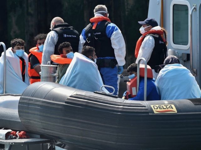 Migrants, believed to have been picked up from boats in the Channel, are brought into the