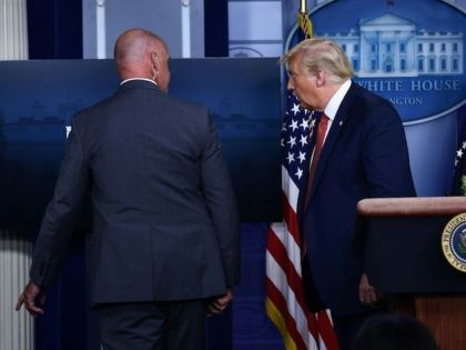 US President Donald Trump is being removed by a member of the secret service from the Brad