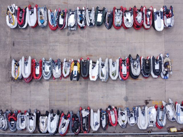 TOPSHOT - An aerial view shows dinghies stored in a Port Authority yard, believed to have been used by migrants picked up at sea whilst crossing the English Channel, in Dover, south-east England on August 15, 2020. (Photo by BEN STANSALL / AFP) (Photo by BEN STANSALL/AFP via Getty Images)