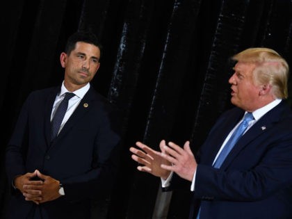 US President Donald Trump delivers remarks on immigration and border security to members of the border patrol as Acting secretary of Homeland Security, Chad Wolf (L) looks on at the international airport in Yuma, Arizona on August 18, 2020. (Photo by Brendan Smialowski / AFP) (Photo by BRENDAN SMIALOWSKI/AFP via …