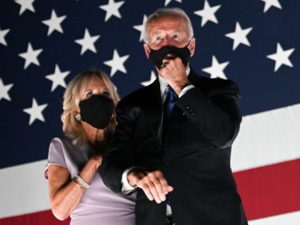 Jill Biden and husband former vice-president and Democratic presidential nominee Joe Biden wear facemasks as they watch fireworks outside the Chase Center in Wilmington, Delaware, at the conclusion of the Democratic National Convention, held virtually amid the novel coronavirus pandemic, on August 20, 2020. (Photo by Olivier DOULIERY / AFP) …
