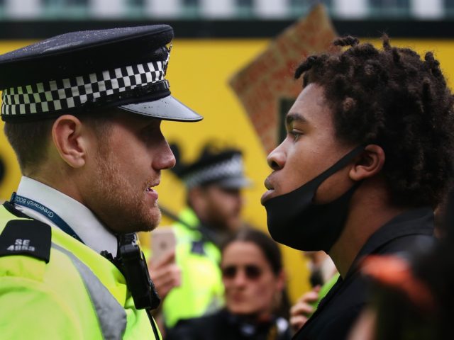 LONDON, UNITED KINGDOM - JUNE 06: A protester confronts a Police Officer during a Black Lives Matter protest on June 06, 2020 in London, United Kingdom. The death of an African-American man, George Floyd, while in the custody of Minneapolis police has sparked protests across the United States, as well …