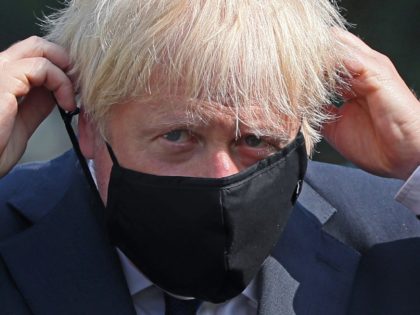 BELFAST, NORTHERN IRELAND - AUGUST 13: Prime Minister Boris Johnson puts on a face mask at the Northern Ireland Ambulance Service HQ during the Prime Minister's visit to Belfast on August 13, 2020 in Belfast, Northern Ireland. (Photo by Brian Lawless - WPA Pool/Getty Images)