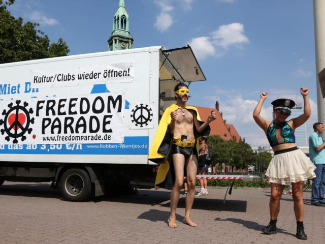 BERLIN, GERMANY - AUGUST 15: Demonstrators attend a protest against coronavirus restrictions dubbed the "Freedom Parade" amidst the ongoing pandemic on August 15, 2020 in Berlin, Germany. Protesters gathered to demonstrate against the restrictions, particularly those keeping dance clubs closed, despite news that the number of daily new confirmed cases …